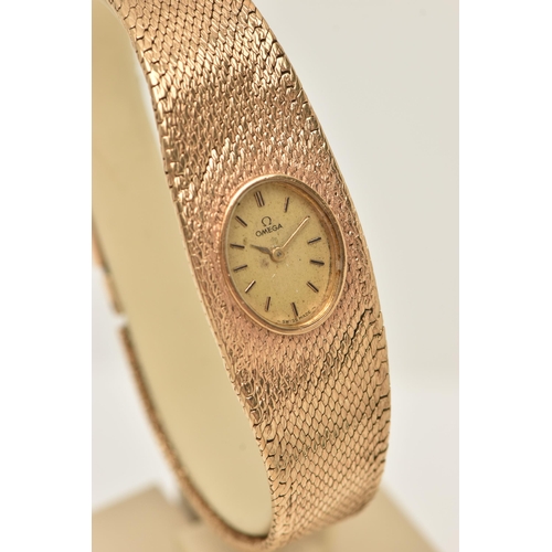 47 - A LADY'S OMEGA 9CT GOLD WRISTWATCH, the oval gold coloured face with baton markers to the mesh brace... 