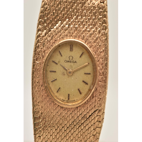 47 - A LADY'S OMEGA 9CT GOLD WRISTWATCH, the oval gold coloured face with baton markers to the mesh brace... 