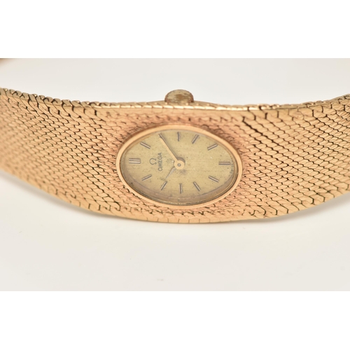 47 - A LADY'S OMEGA 9CT GOLD WRISTWATCH, the oval gold coloured face with baton markers to the mesh brace... 