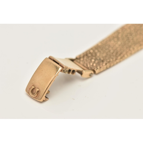 47 - A LADY'S OMEGA 9CT GOLD WRISTWATCH, the oval gold coloured face with baton markers to the mesh brace... 