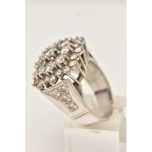 49 - A DIAMOND CLUSTER RING, designed as a three tier cluster of claw set brilliant cut diamonds, to the ... 