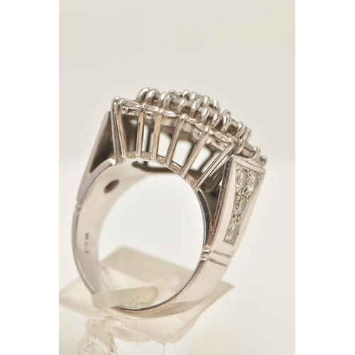 49 - A DIAMOND CLUSTER RING, designed as a three tier cluster of claw set brilliant cut diamonds, to the ... 