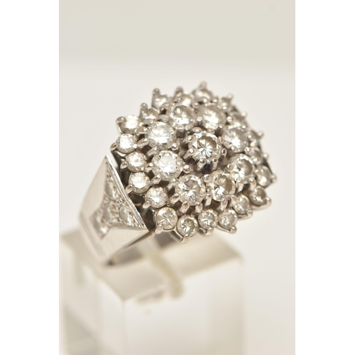 49 - A DIAMOND CLUSTER RING, designed as a three tier cluster of claw set brilliant cut diamonds, to the ... 