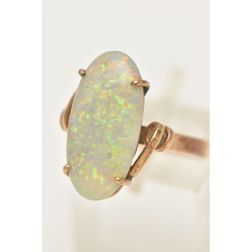 52 - AN OPAL RING, designed as an oval opal cabochon in a four claw setting to the twist design shoulders... 