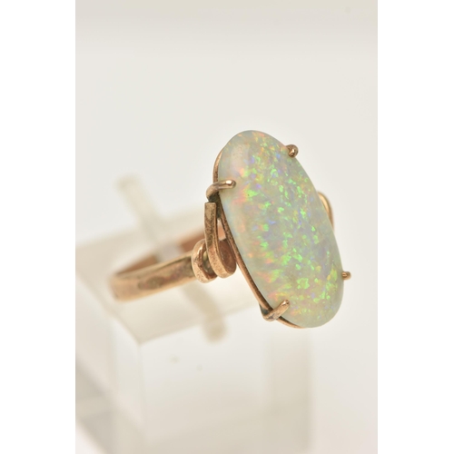 52 - AN OPAL RING, designed as an oval opal cabochon in a four claw setting to the twist design shoulders... 