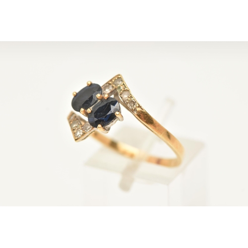 57 - A SAPPHIRE AND DIAMOND DRESS RING, of cross over design, set with two oval shape mixed cut sapphires... 