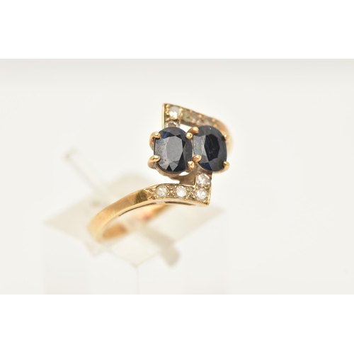 57 - A SAPPHIRE AND DIAMOND DRESS RING, of cross over design, set with two oval shape mixed cut sapphires... 