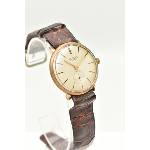 73 - A VINTAGE 9CT YELLOW GOLD BERNEX WRISTWATCH, the silver coloured dial with illuminous gilt hourly ap... 