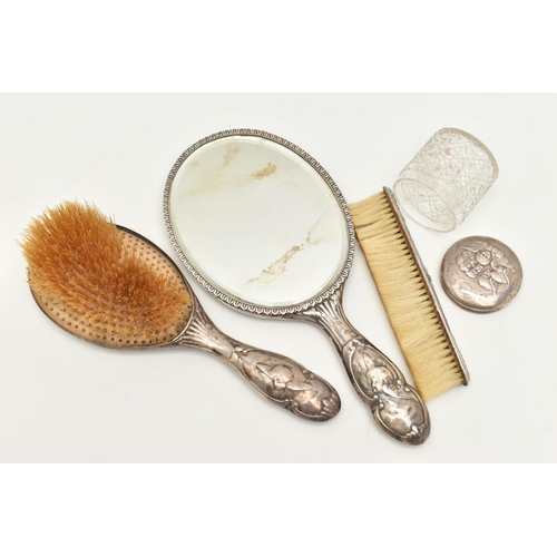 115 - A GEORGE V SILVER VANITY SET, to include a hand held mirror and hair brush with embossed cherub deta... 