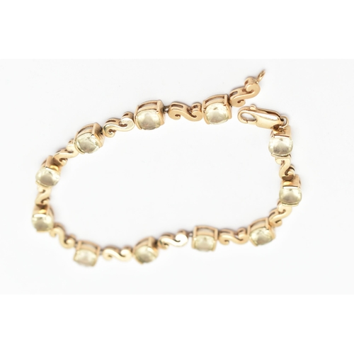 83 - A GEM SET BRACELET, a yellow metal bracelet with scrolling fancy links interspaced with cushion cut ... 