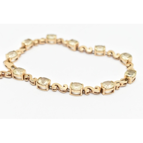 83 - A GEM SET BRACELET, a yellow metal bracelet with scrolling fancy links interspaced with cushion cut ... 