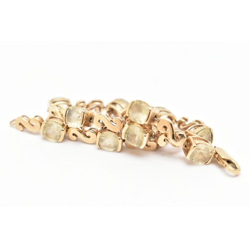 83 - A GEM SET BRACELET, a yellow metal bracelet with scrolling fancy links interspaced with cushion cut ... 