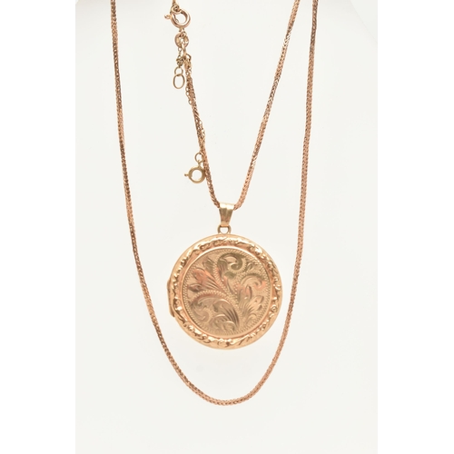 84 - A 9CT GOLD LOCKET NECKLACE, a circular form locket with scrolling acanthus detail, approximate width... 