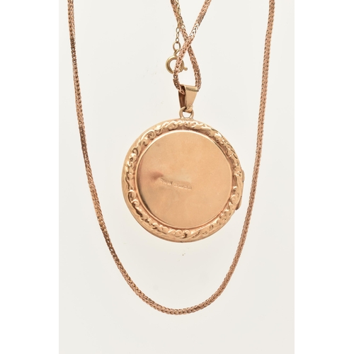 84 - A 9CT GOLD LOCKET NECKLACE, a circular form locket with scrolling acanthus detail, approximate width... 