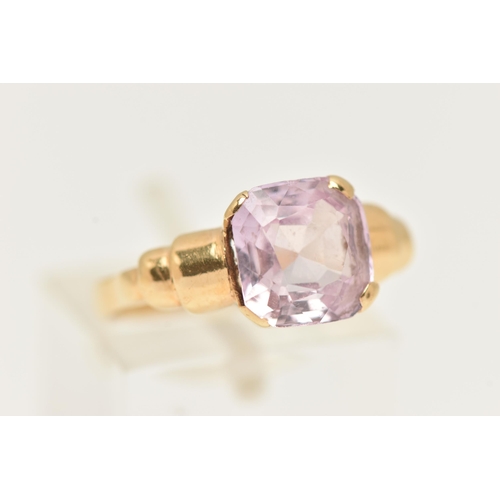 85 - A GEM SET RING, a light pink cushion cut stone, assessed as sapphire, prong set in yellow metal, lea... 