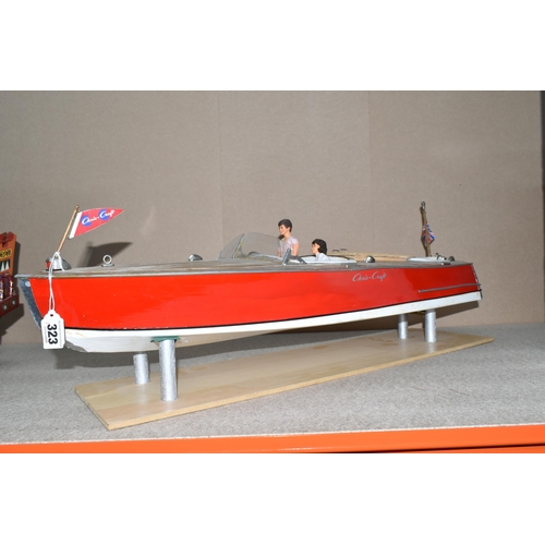 323 - A VINTAGE HANDICRAFTS 'CHRIS CRAFT' MODEL SPEED BOAT, 'Foxy Lady' fully assembled on a stand  and pa... 