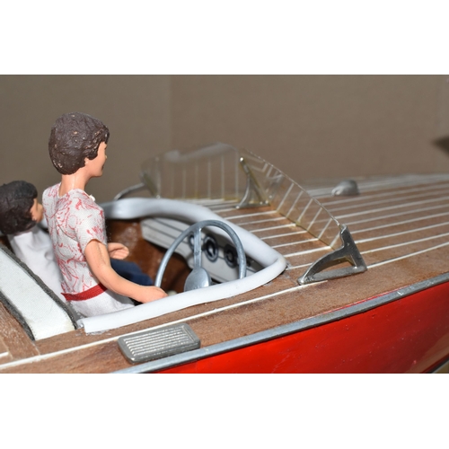 323 - A VINTAGE HANDICRAFTS 'CHRIS CRAFT' MODEL SPEED BOAT, 'Foxy Lady' fully assembled on a stand  and pa... 