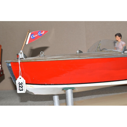 323 - A VINTAGE HANDICRAFTS 'CHRIS CRAFT' MODEL SPEED BOAT, 'Foxy Lady' fully assembled on a stand  and pa... 