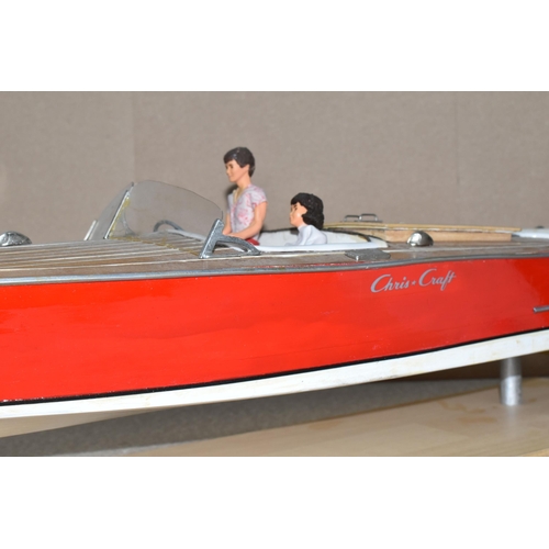 323 - A VINTAGE HANDICRAFTS 'CHRIS CRAFT' MODEL SPEED BOAT, 'Foxy Lady' fully assembled on a stand  and pa... 