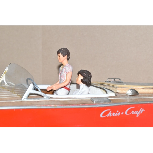 323 - A VINTAGE HANDICRAFTS 'CHRIS CRAFT' MODEL SPEED BOAT, 'Foxy Lady' fully assembled on a stand  and pa... 