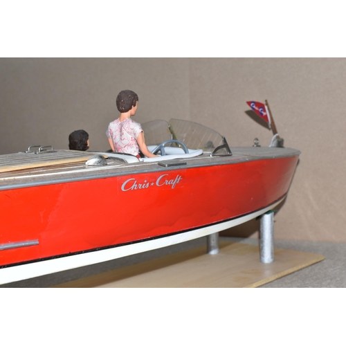 323 - A VINTAGE HANDICRAFTS 'CHRIS CRAFT' MODEL SPEED BOAT, 'Foxy Lady' fully assembled on a stand  and pa... 