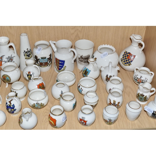 354 - A QUANTITY OF WH GOSS CRESTED WARE VESSELS, over ninety pieces, in forms to include an ancient salt ... 