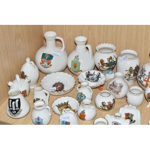 354 - A QUANTITY OF WH GOSS CRESTED WARE VESSELS, over ninety pieces, in forms to include an ancient salt ... 