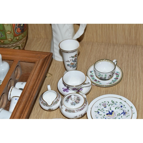 420 - A COLLECTION OF PORCELAIN THIMBLES AND MINIATURE TEA SET, comprising two small wooden display cases,... 