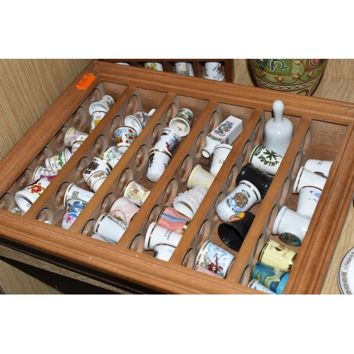 420 - A COLLECTION OF PORCELAIN THIMBLES AND MINIATURE TEA SET, comprising two small wooden display cases,... 