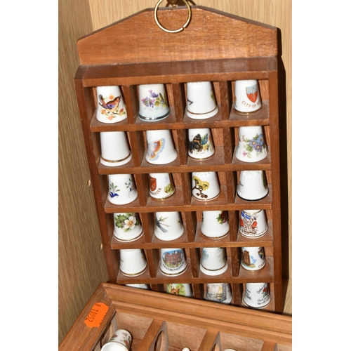 420 - A COLLECTION OF PORCELAIN THIMBLES AND MINIATURE TEA SET, comprising two small wooden display cases,... 