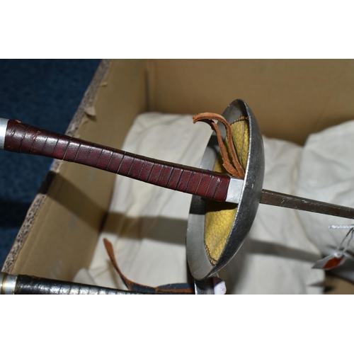 424 - A BOX OF FENCING EQUIPMENT comprising two foils marked Leon Paul No. 5, a Leon Paul guard, two glove... 