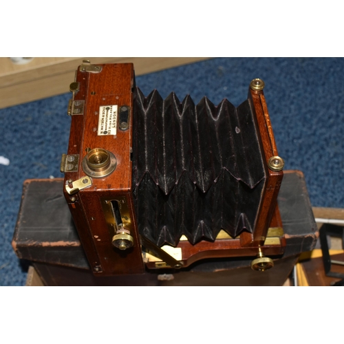 434 - A MAHOGANY QUARTER PLATE CAMERA BY W. WATSON AND SONS, with brass fittings, lens board but no lens, ... 