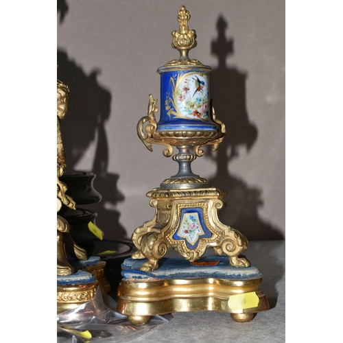 460 - AN ANTIQUE FRENCH GILT METAL MANTEL CLOCK AND GARNITURE SET, the mantel clock has a hand painted por... 