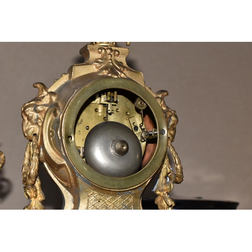 460 - AN ANTIQUE FRENCH GILT METAL MANTEL CLOCK AND GARNITURE SET, the mantel clock has a hand painted por... 