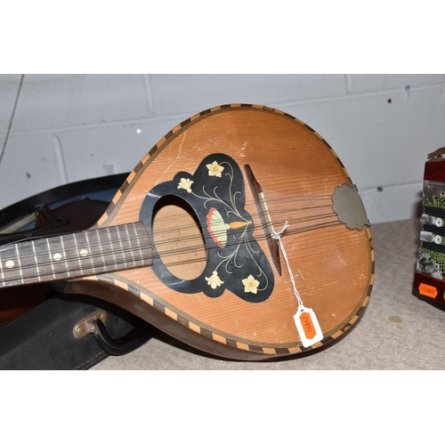 546 - A GROUP OF MUSICAL INSTRUMENTS, comprising a flat back Mandolin (Mandola), length 63cm, a Concertina... 