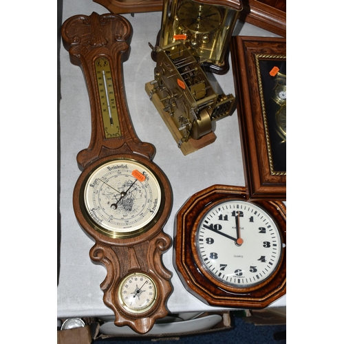 585 - A GROUP OF CLOCKS, comprising a modern large mantel clock, height 50cm, a Kienzle wall clock with ce... 