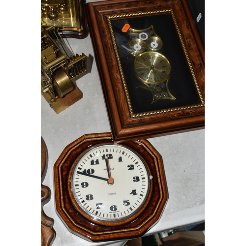 585 - A GROUP OF CLOCKS, comprising a modern large mantel clock, height 50cm, a Kienzle wall clock with ce... 