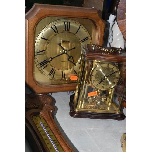 585 - A GROUP OF CLOCKS, comprising a modern large mantel clock, height 50cm, a Kienzle wall clock with ce... 