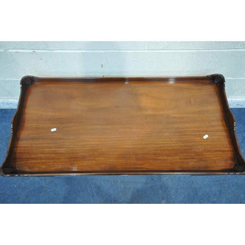 1202 - A REPRODUCTION MAHOGANY COFFEE TABLE, with a wavy raised gallery, raised on square legs, united by a... 