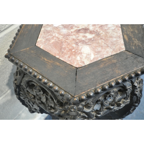 1203 - A CHINESE HARDWOOD JARDINIERE STAND, with a hexagonal marble insert, foliate carvings to apron and l... 