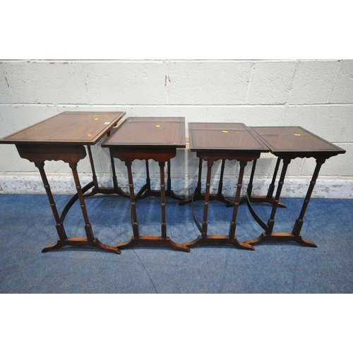 1209 - A REPRODUCTION MAHOGANY QUARTETTO NEST OF FOUR TABLES, raised on turned legs, shaped feet, united by... 