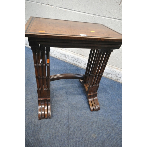 1209 - A REPRODUCTION MAHOGANY QUARTETTO NEST OF FOUR TABLES, raised on turned legs, shaped feet, united by... 