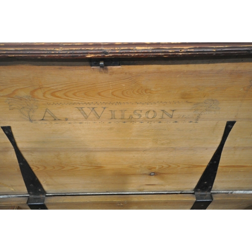 1217 - A STAINED PINE CHEST, with twin rope handles, the hinged lid enclosing a candle box, with two drawer... 