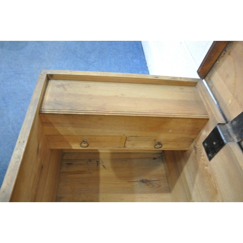 1217 - A STAINED PINE CHEST, with twin rope handles, the hinged lid enclosing a candle box, with two drawer... 