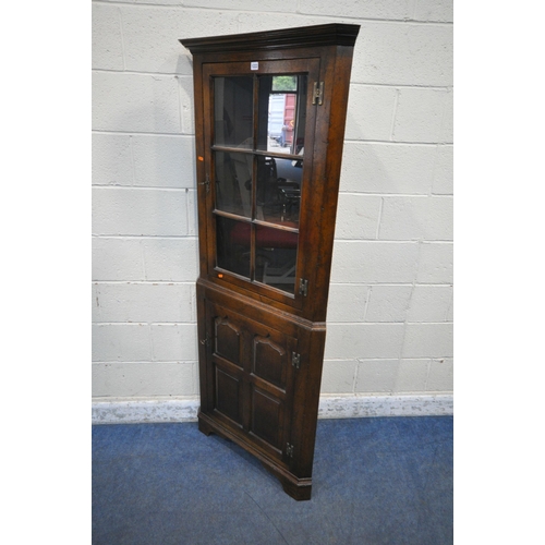 1222 - POSSIBLY TITCHMARSH AND GOODWIN, A GOOD QUALITY SOLID OAK CORNER CUPBOARD, the glazed door enclosing... 