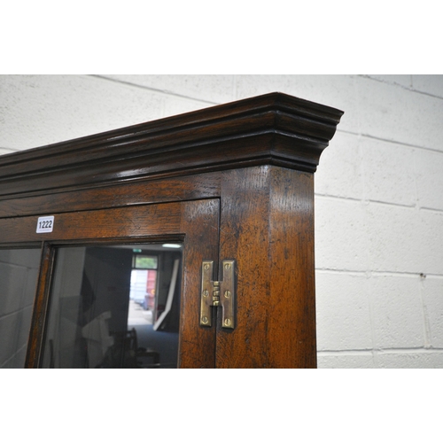 1222 - POSSIBLY TITCHMARSH AND GOODWIN, A GOOD QUALITY SOLID OAK CORNER CUPBOARD, the glazed door enclosing... 