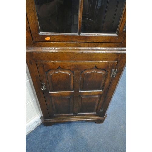 1222 - POSSIBLY TITCHMARSH AND GOODWIN, A GOOD QUALITY SOLID OAK CORNER CUPBOARD, the glazed door enclosing... 