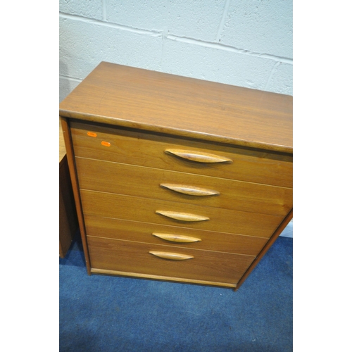 1228 - AN AUSTINSUITE MID CENTURY TEAK DRESSING TABLE, with a triple mirror, seven assorted drawers, raised... 