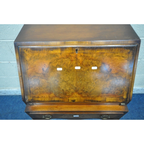 1247 - AN EARLY 20TH CENTURY BURR WALNUT BUREAU, the fall front door enclosing a fitted interior, above a s... 