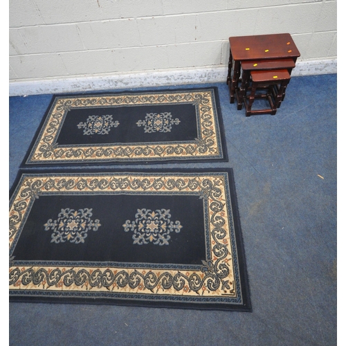 1272 - A PAIR OF BLUE GROUND RECTANGULAR RUGS, with foliate patterns, along with a nest of three tables (co... 